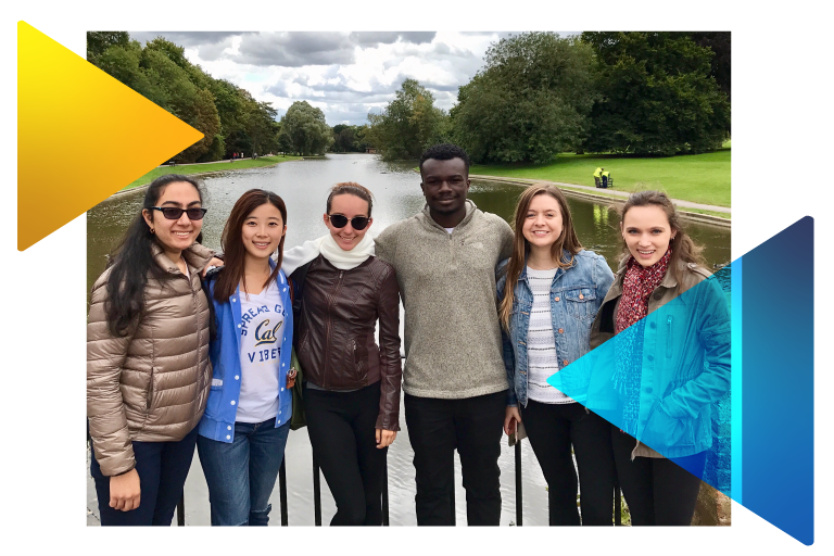 Group of students standing in front of a body of water