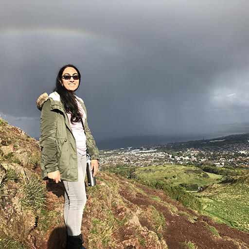 Student Shalina Bulchandani on a hill overlooking Edinburgh